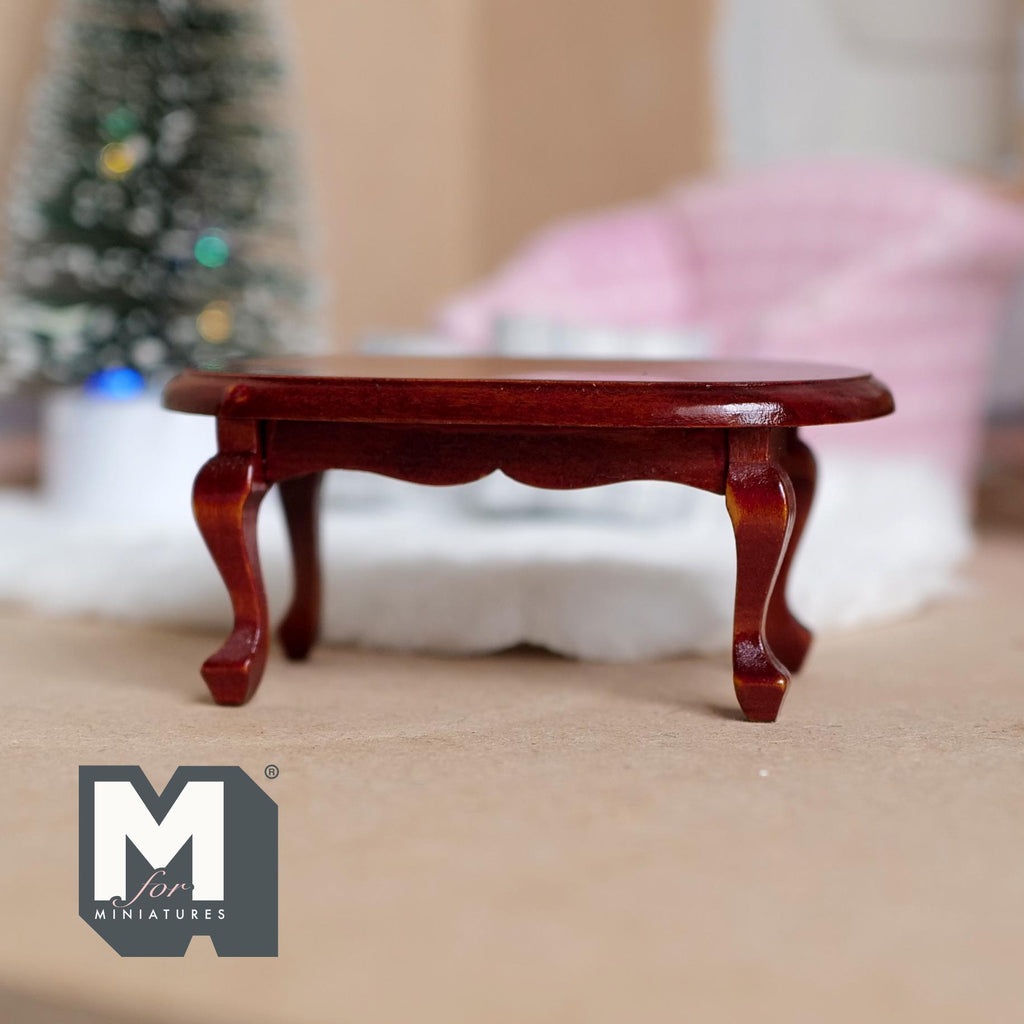 1:12 scale miniature brown wood oval coffee table with cabriole legs, mahogany tone, shown in a living room setting