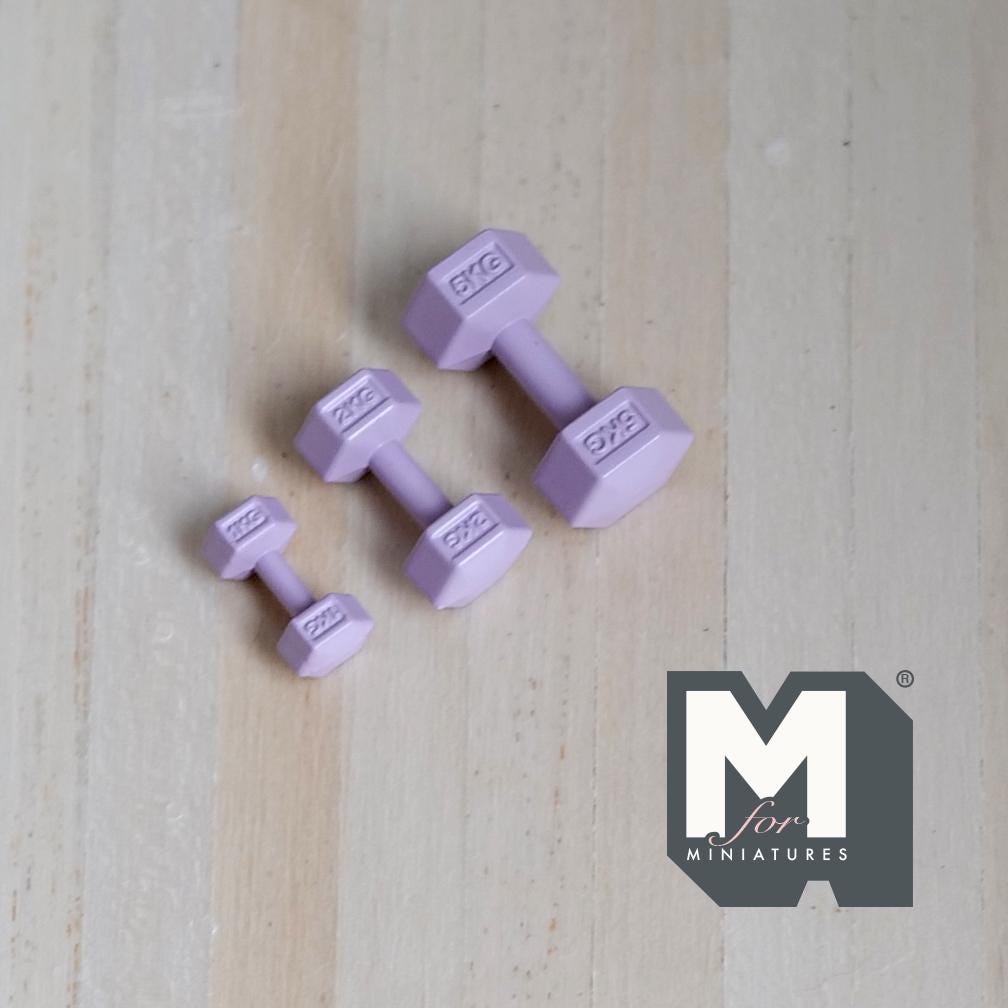 1:12 scale miniature metal hexagon dumbbells in light purple, set of 3 graduated sizes, on a light wood surface