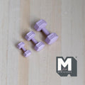 1:12 scale miniature metal hexagon dumbbells in light purple, set of 3 graduated sizes, on a light wood surface