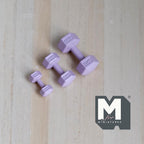 1:12 scale miniature metal hexagon dumbbells in light purple, set of 3 graduated sizes, on a light wood surface