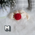 1:12 scale miniature resin cat in cream lying down playing with a red yarn ball, shown on a white fur rug