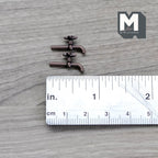 1:12 scale miniature wall mount garden taps in bronze with cross handles, set of 2, shown with a ruler