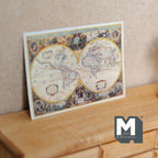 1:12 scale miniature world map print on cardstock with two hemispheres in antique tones, leaning on a wood dresser