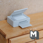 1:12 scale miniature gray all in one printer with paper tray and open lid, non working, shown on a wood desk