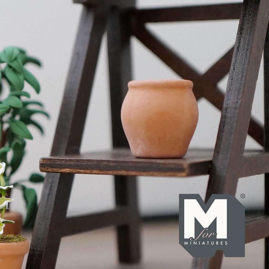1:12 scale miniature terracotta clay planter with a round belly shape, unglazed orange-brown, displayed on a dark wood plant stand