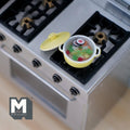 1:12 scale miniature vegetable soup in a yellow metal pot with lid, shown on a kitchen stove top