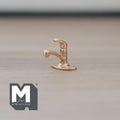 1:12 scale miniature metal single lever faucet in brass with a curved spout, shown on a wood surface