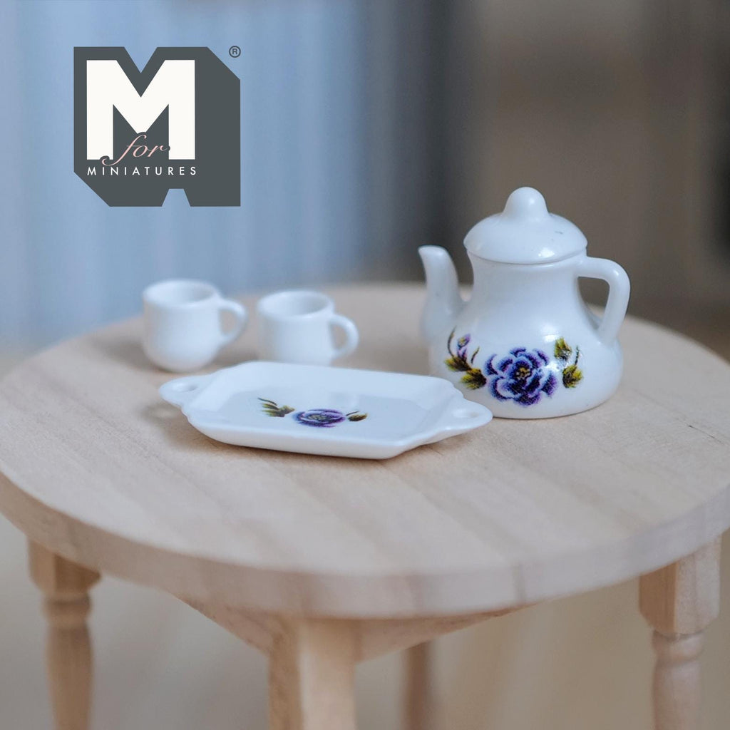 1:12 scale miniature white porcelain teapot set with 2 cups and tray, purple and blue floral pattern, set of 4, on a wood table