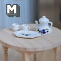 1:12 scale miniature white porcelain teapot set with 2 cups and tray, purple and blue floral pattern, set of 4, on a wood table
