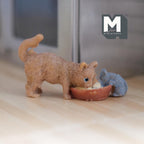 1:12 scale miniature resin cat and mouse drinking milk from a bowl, tan cat and gray mouse, shown on a wood floor