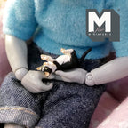 1:12 scale miniature resin cuddling kittens lying upside down, black and white, shown held in an artist figure's lap