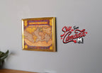 1:12 scale miniature antique world map in gold metal frame, sepia toned, shown hanging on a gray wall
