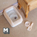 1:12 scale miniature cat litter box in pale yellow with lid, scoop and food bowl, shown filled with litter on the floor