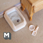 1:12 scale miniature cat litter box in pale yellow with lid, scoop and food bowl, shown filled with litter on the floor