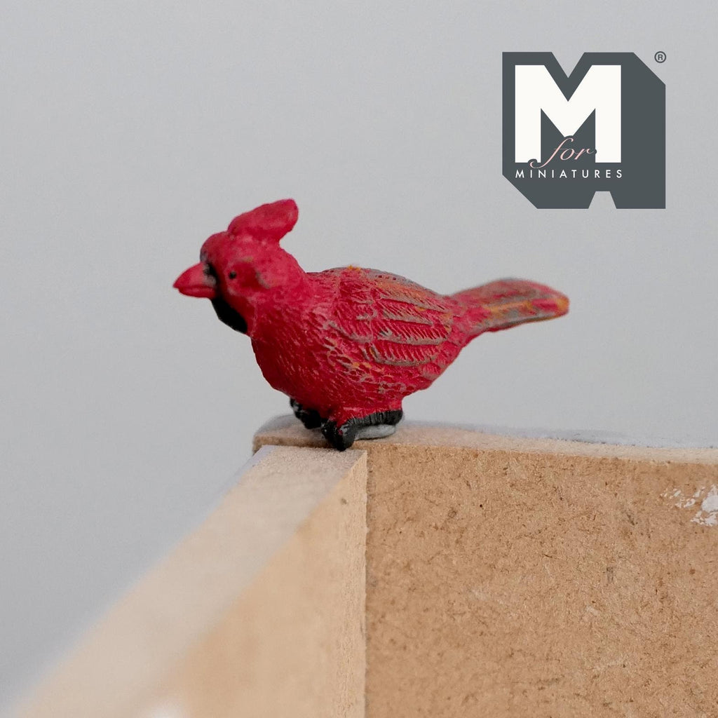 1:6 scale miniature resin cardinal bird figure in red with black face, perched on a wood ledge