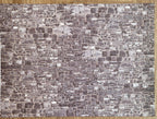 Miniature gray embossed stone wall sheet, irregular rubble stone pattern in mixed gray tones, full sheet shown flat