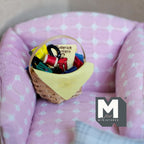 1:12 scale miniature knitting basket with yarn and needles, woven basket with yellow cloth, on a pink armchair