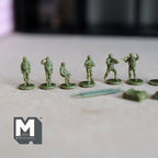 1:150 scale miniature army soldier figures in olive green, unassembled set of 16, standing in a row on a gray surface