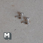 1:12 scale miniature silver taps, faucet spigot set of 2 with cross handles, requires mounting, lying on a board