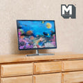 1:12 scale miniature flat screen TV on stand with colorful aquarium fish screen, non working, shown on a wood dresser