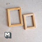 1:12 scale miniature wood picture frames in natural finish, set of 2 rectangular sizes, lying flat on a board