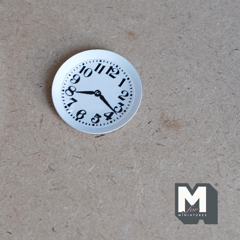 1:12 scale miniature white wall clock with bold black numbers and hands, non working, shown flat on a board