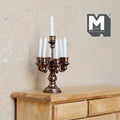 1:12 scale miniature bronze metal candelabra with 5 arms and white candles, shown on a wood dresser