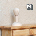 1:12 scale miniature wood mannequin head hat stand with round base, unfinished light wood, shown on a wood dresser