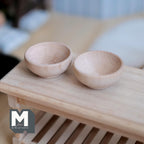 1:12 scale miniature wood bowls, set of 2, round unfinished light wood shown on a slatted wood table