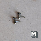 1:12 scale miniature metal faucets in brass with an aged finish, set of 2, shown on a brown craft board