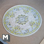1:12 scale miniature round area rug in cream with floral medallion, yellow and blue flower border, shown flat