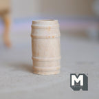 1:12 scale miniature wood wine barrel, small, unfinished pale wood with raised bands, shown on a gray floor