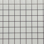 Miniature white embossed square tile sheet with black grout lines, close view of the glossy grid pattern