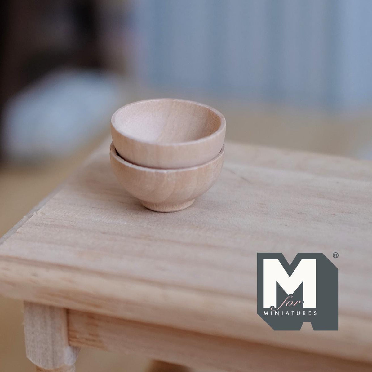1:12 scale miniature wood bowls in natural finish, set of 2, shown stacked on a light wood table
