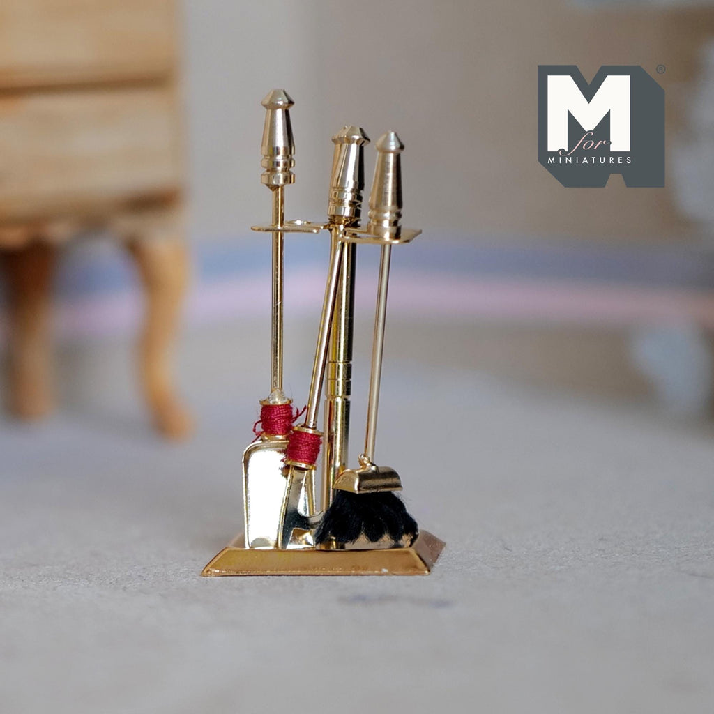 1:12 scale miniature brass fireplace tool set with stand, poker, shovel and brush, shown on a carpet floor