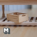 1:12 scale miniature unpainted wood slatted crate with hand holes, shown on a wood shelf