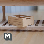 1:12 scale miniature unpainted wood slatted crate with hand holes, shown on a wood shelf