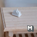 1:12 scale miniature white ceramic toast rack, shown on a light wood table