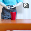 1:12 scale miniature large metal thermal cup in red, tapered tumbler shown on a wood table beside a poseable figure