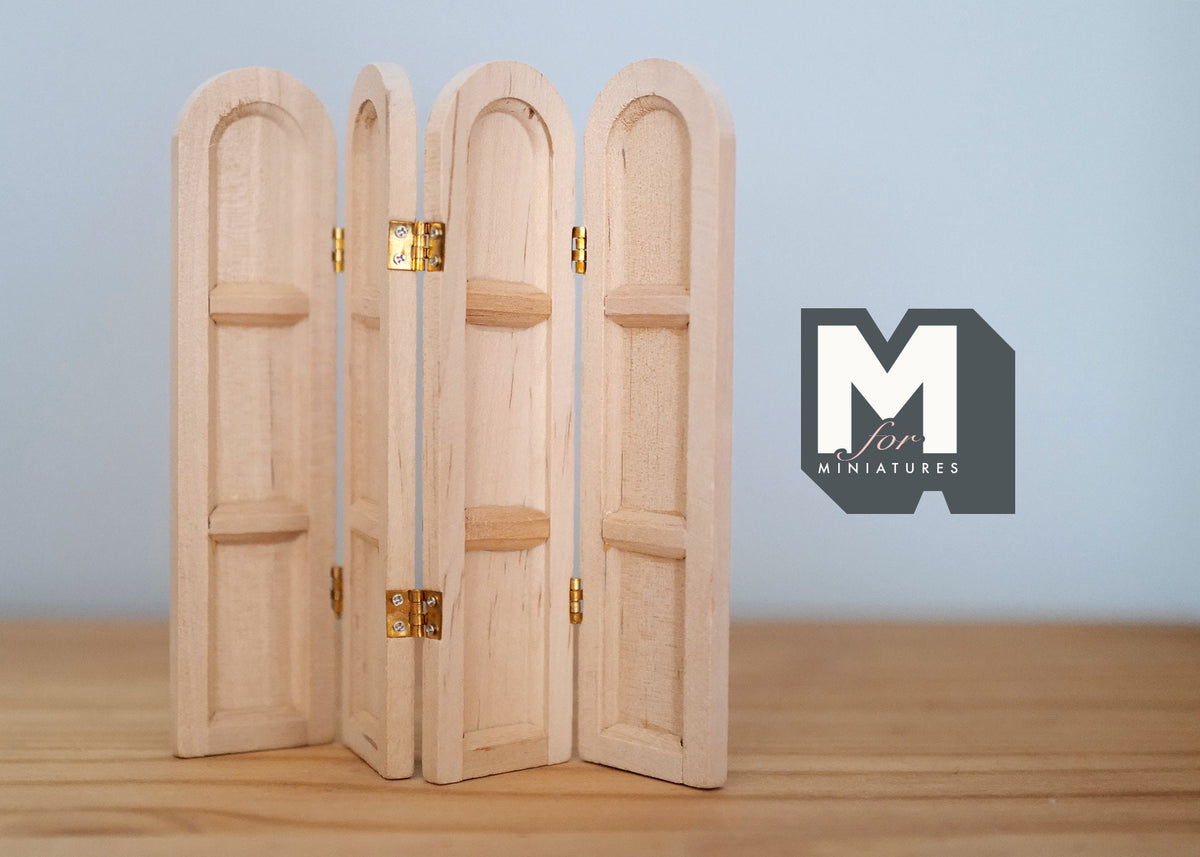 1:12 scale miniature unpainted wood dressing screen, 3 panels with arched tops and gold hinges, shown on a wood table