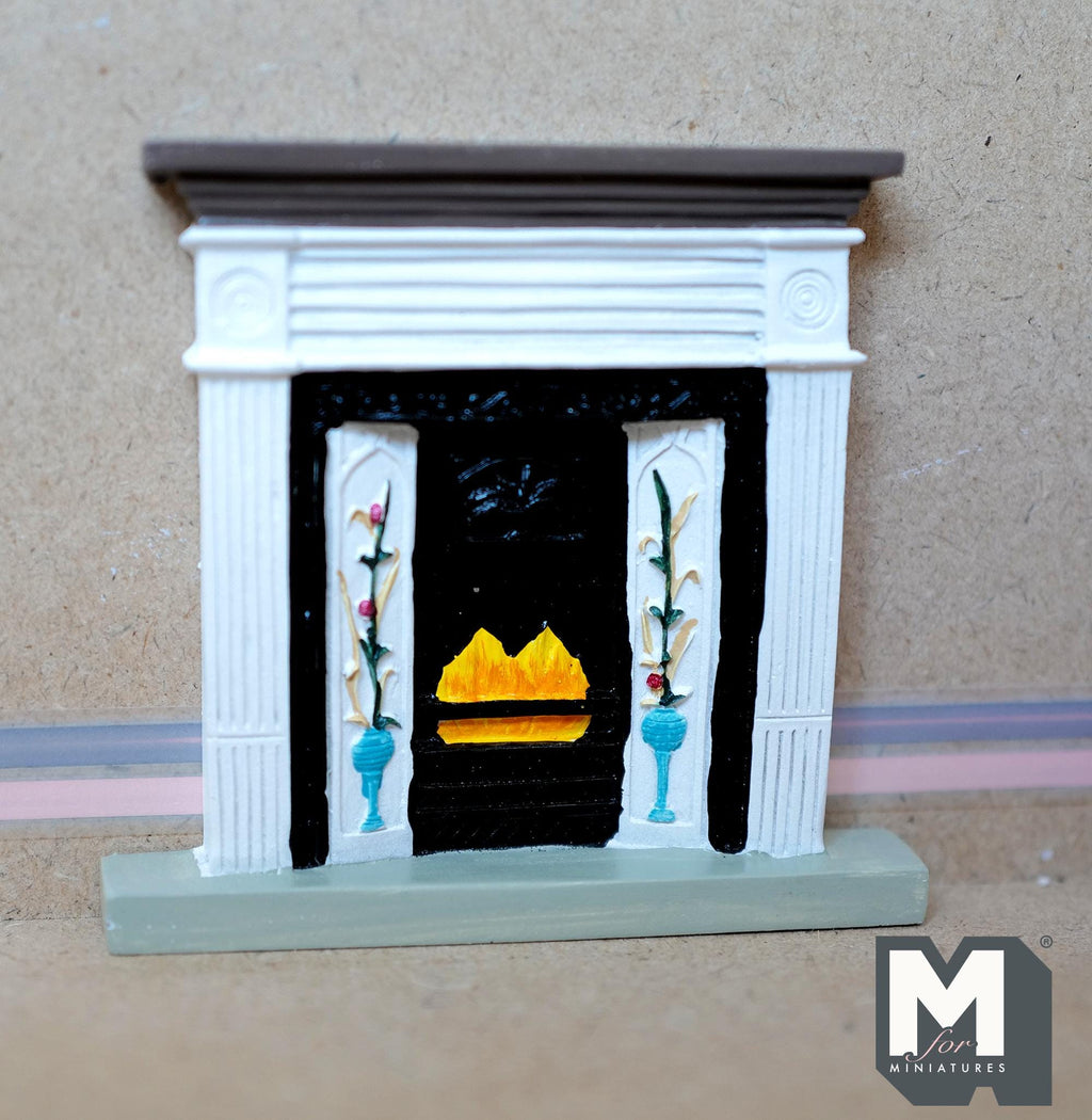 1:12 scale miniature cast resin Victorian style fireplace with white mantel, floral tile panels and a black grate with flames
