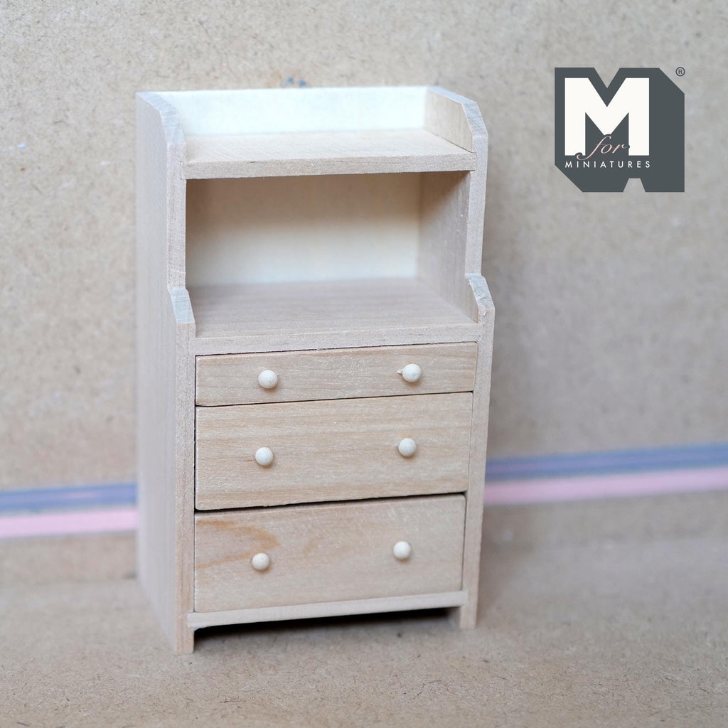 1:12 scale miniature unpainted wood bureau with 3 drawers and open shelf above, white knobs, shown against a wall