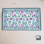 1:12 scale miniature floral area rug in cream with green border, pink and yellow flowers on trailing vines