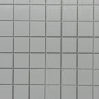 Miniature white embossed square tile sheet with gray grout, close view of the raised square tiles