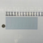 1:12 scale miniature ornate fleur de lis wainscot panel in white foamboard, shown with a ruler and coin for scale