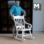 1:12 scale miniature wood rocking chair in white with a spindle back and scroll arms, shown with a poseable figure