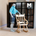 1:12 scale miniature wood rocking chair in pine with spindle back and arms, shown beside an artist figure