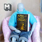 1:12 scale miniature notebook with blank pages, black book of potions cover with gold lettering, held by a poseable figure