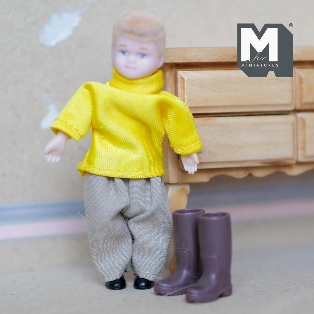 1:12 scale miniature kids rubber rain boots in brown, pair, shown beside a child doll in a yellow sweater
