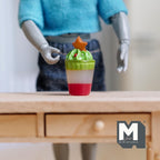 1:12 scale miniature Christmas dessert drink with star cookie topper, large, red, white and green layers, on a wood desk